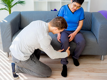 Physiotherapist providing care to a user in his home