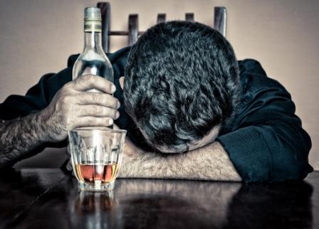 Photo of a man with a bottle of alcohol.